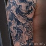 freehand skulls on arm design by maarten