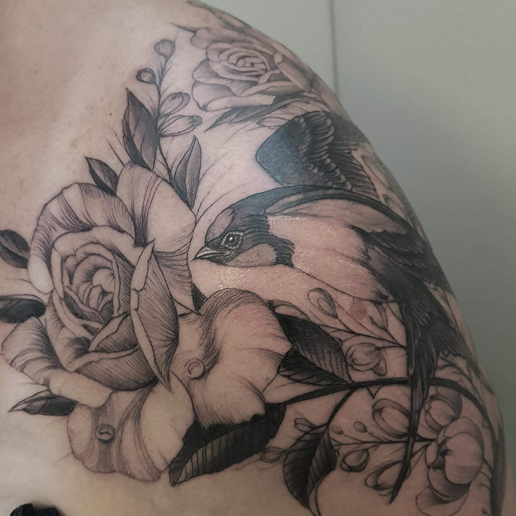 Swallow with flowers tattoo